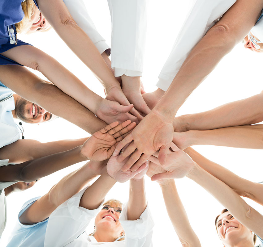 Directly below shot of multiethnic medical team stacking hands over white background